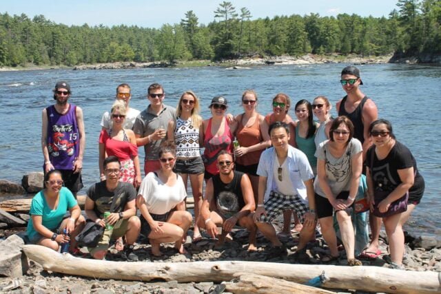 Group picture by Ottawa river at Wilderness tour resort